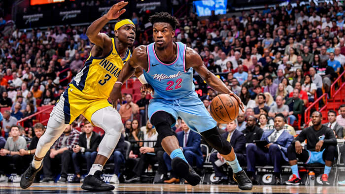 Jimmy Butler drives to the basket against Aaron Holiday